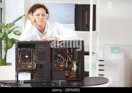 Portrait of tired electronic technician in service center Stock Photo