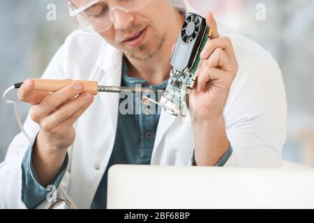 Electronic technician working in service center Stock Photo