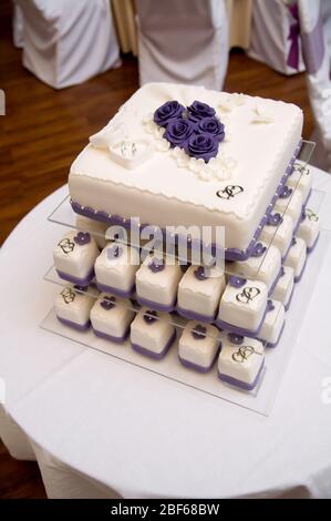 wedding cakes with violet flowers and rings Stock Photo
