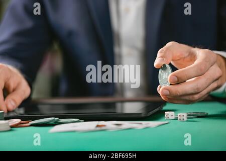 Man with tablet computer playing poker online, closeup Stock Photo