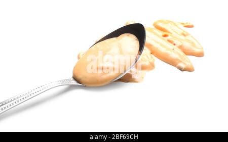 Spoon with tasty sauce on white background Stock Photo