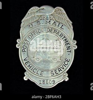 MVS employee chest badge number 18609. U.S. Post Office Department Motor Vehicle Service (MVS) cap badge, number 18609, with vertical hinged pin and safety clasp on verso. Spread eagle surmounts circular medallion with upper portion marked 'U.S. MAIL.' Medallion bears U.S. Stock Photo