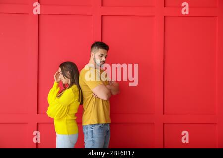 Quarreled young couple on color background Stock Photo