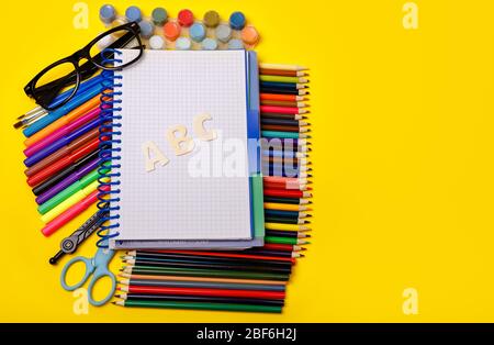 Top view school supplies with blank notepad on table. Back to school Stock Photo