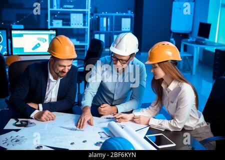 Engineers working in office at night Stock Photo