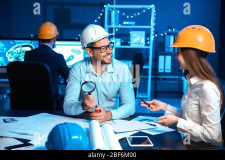 Engineers working in office at night Stock Photo