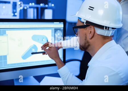 Engineers working in office at night Stock Photo