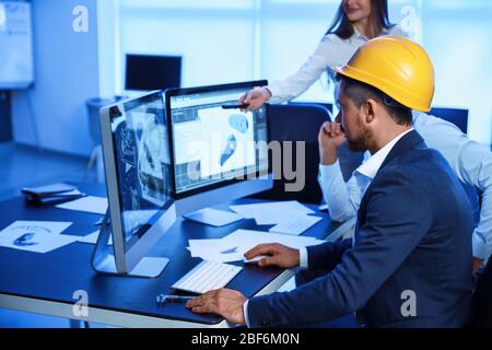 Engineers working in office at night Stock Photo