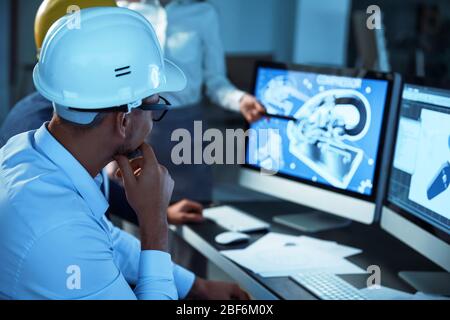 Engineers working in office at night Stock Photo