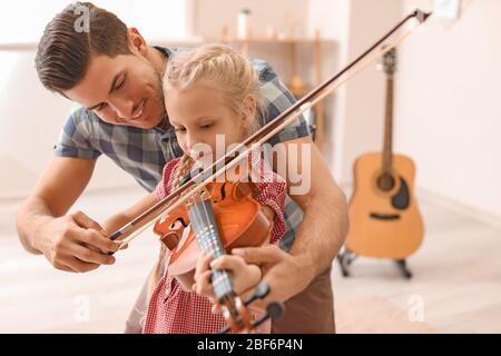 Teacher giving music lessons at school Stock Photo