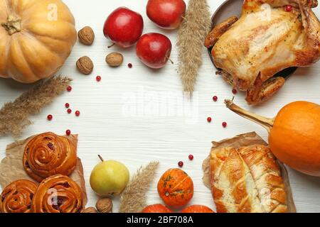 Frame made of tasty baked turkey and different food for Thanksgiving day on wooden table Stock Photo