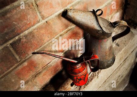 Vintage oil cans in garage. Stock Photo