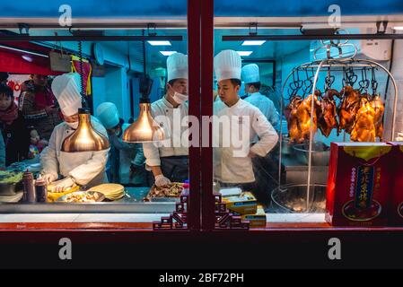 Small restaurant served takeaway wraps with Peking duck in Nanluoguxiang - famous commercial hutong in Beijing, China Stock Photo