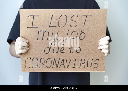 Job loss due to COVID-19 virus pandemic concept. Unrecognizable person holds sign 'I lost my job Stock Photo
