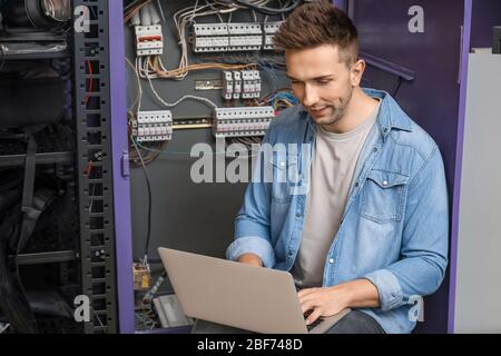 Technician engineer with laptop in server room Stock Photo