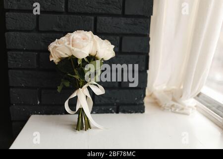 Wedding bouquet of roses in front on the background of the black wall Stock Photo