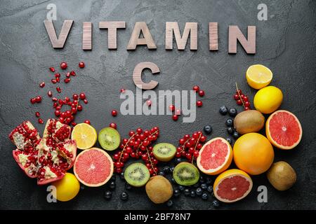 Healthy products rich in vitamin C on dark background Stock Photo