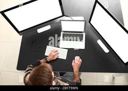 Male programmer working in office, top view Stock Photo