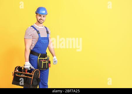 Handsome male worker on color background Stock Photo