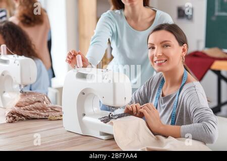 Young woman with teacher during tailor's class in atelier Stock Photo