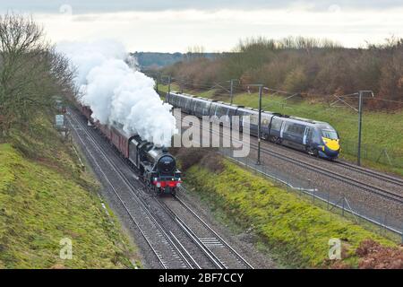 LMS Black 5 Steam engine races a Class 395 High Speed Train though Kent, UK on HS1 Stock Photo