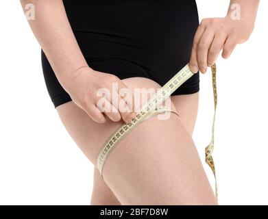 Overweight woman with measuring tape on white background, closeup. Weight loss concept Stock Photo