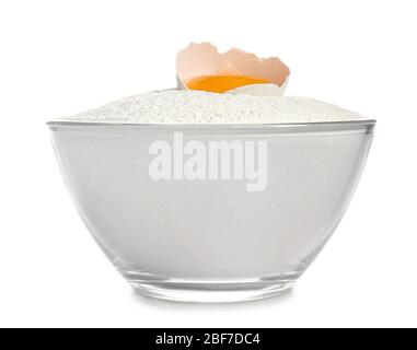 Raw chicken egg and flour in bowl on white background Stock Photo