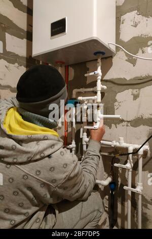 Worker is working on installing pipes for floor heating.2020 Stock Photo
