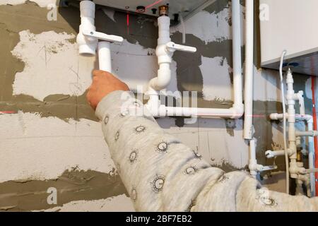 Worker is working on installing pipes for floor heating.2020 Stock Photo