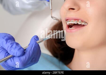 Teenage girl with dental braces visiting orthodontist in clinic Stock Photo