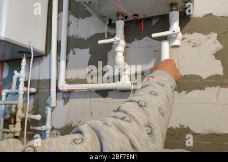Worker is working on installing pipes for floor heating.2020 Stock Photo