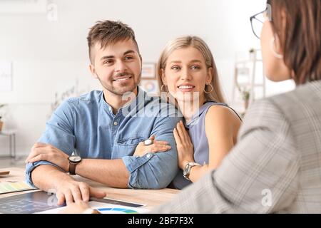Female interior designer working with couple in office Stock Photo