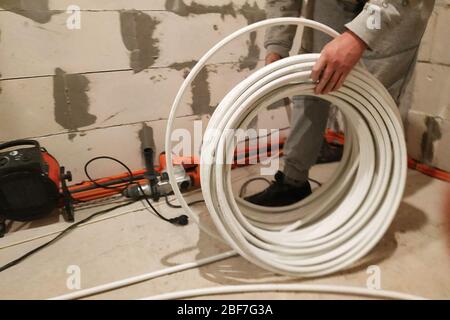 Underfloor heating is mounted on a pipeline installer, heating system and underfloor heating.2020 Stock Photo