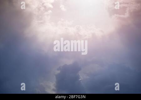 Sunlight breaks through the dense cloudy sky Stock Photo