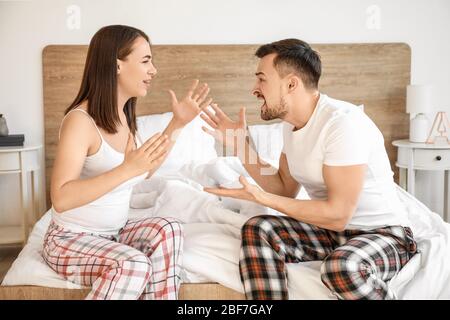 Young couple quarreling in bedroom Stock Photo