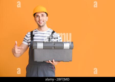 Handsome male worker on color background Stock Photo