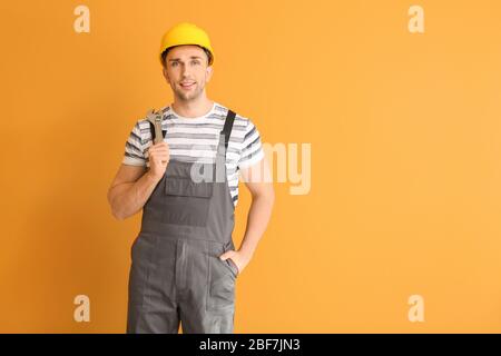 Handsome male worker on color background Stock Photo