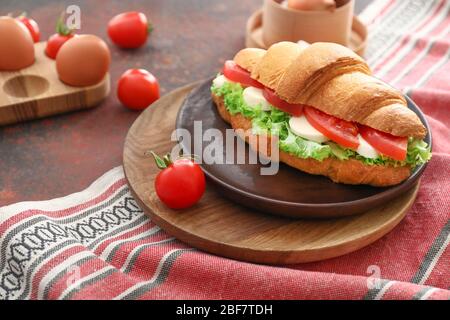 Tasty croissant sandwich on table Stock Photo