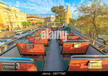 Seville, Andalusia, Spain - April 19, 2016: city sightseeing of Seville from point of view of a tourist above Hop-On Hop-Off Bus. In the distance Stock Photo