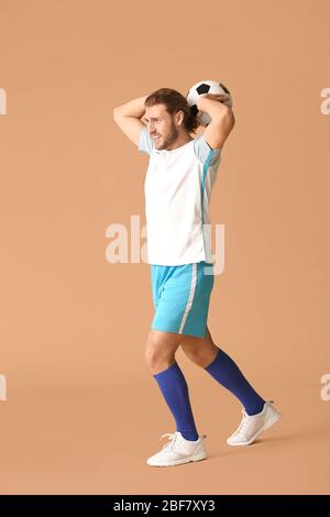 Male football player on color background Stock Photo