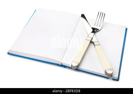 Cook book with cutlery on white background Stock Photo