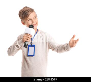 Little journalist with microphone on white background Stock Photo