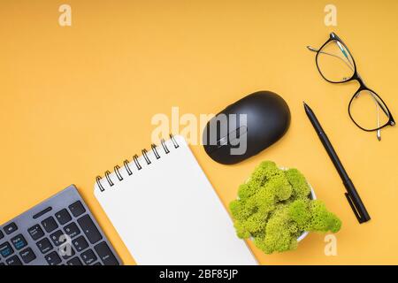Keyboard, computer mouse and cofffe on yellow background Stock Photo