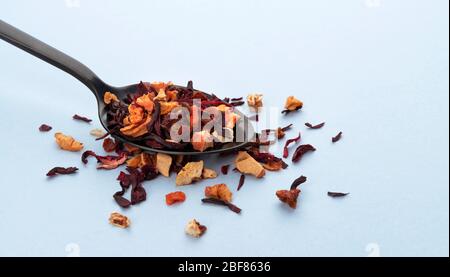 Fruit tea leaves in spoon on white background Stock Photo
