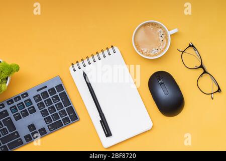 Keyboard, computer mouse and cofffe on yellow background Stock Photo