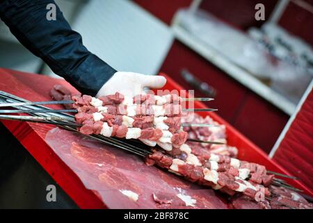 Kebab or kebap on metal skewer barbecue in the kebap restaurant. Traditional Turkish Adana Kebab Stock Photo