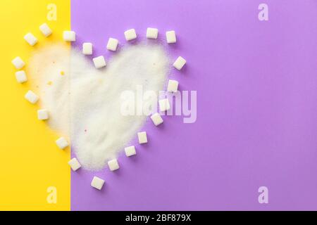 Heart shape made of sugar on color background Stock Photo