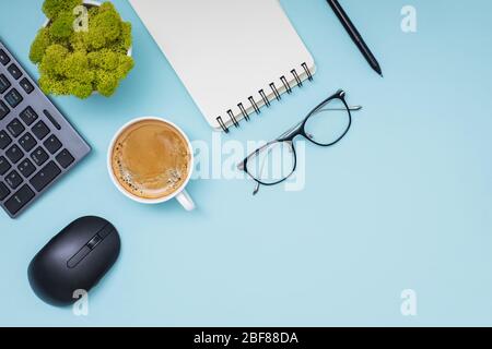 Flat lay with coffee, keyboard, empty paper notepad and other office related objects Stock Photo
