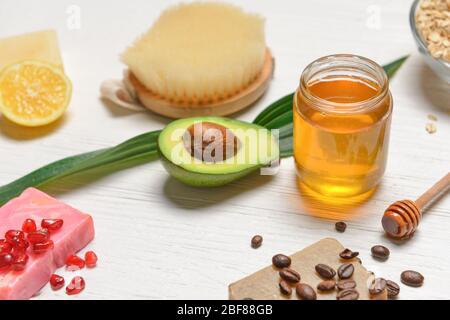 Spa items and honey on white wooden background Stock Photo