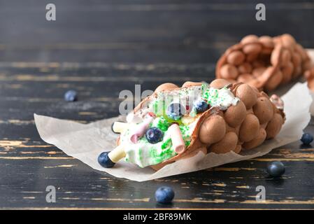 Delicious sweet bubble waffle on table Stock Photo